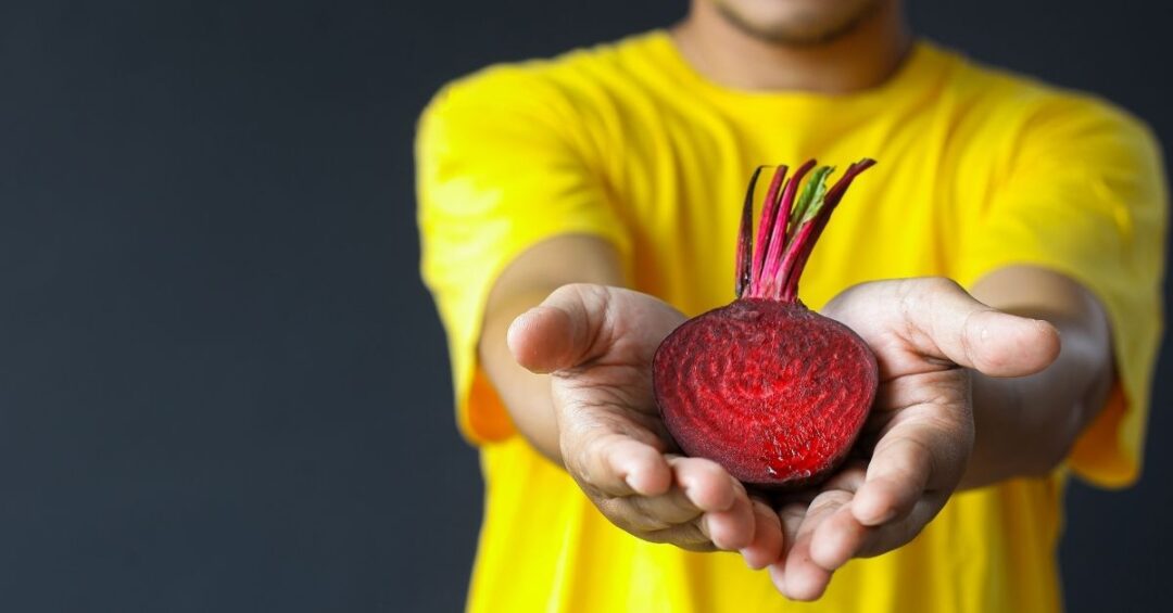 Hände halten aufgeschnittene Rote Bete als Symbol für Rote Bete Herzgesundheit